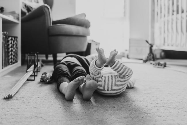black and white image of brothers feet with Lifestyle Newborn Photographer Perth