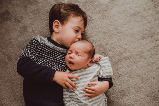 Big brother kissing baby brother with Lifestyle Newborn Photographer Perth