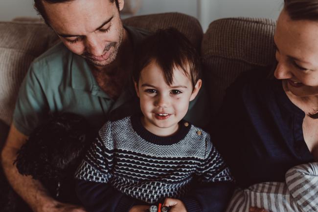 Little boy on his dad's lap with Lifestyle Newborn Photographer Perth