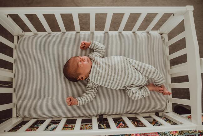 Top down image of baby in a bassinet with Lifestyle Newborn Photographer Perth