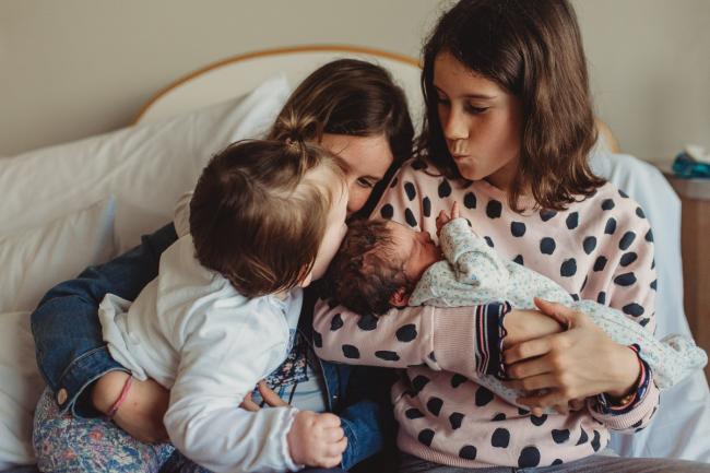 Newborn-and-Fresh-48-Photographer-Perth-SJOG-Mt-Lawley-18-of-51 Sister kissing new baby while on laps of older sisters with Perth Fresh 48 photographer at SJOG Mt Lawley