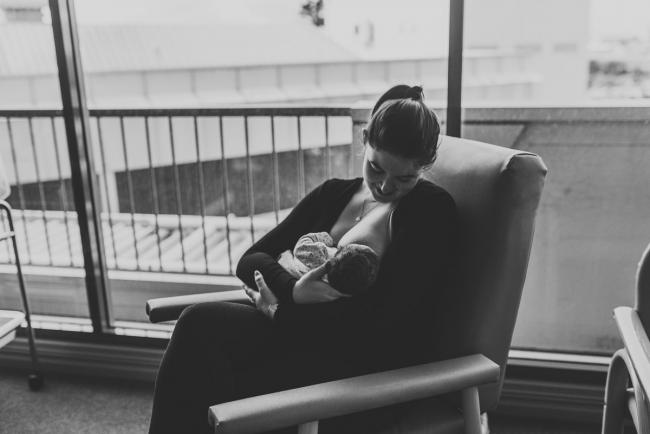 Black and white image of mother breastfeeding her new baby daughter with Perth Fresh 48 Photographer at SJOG Mt Lawley