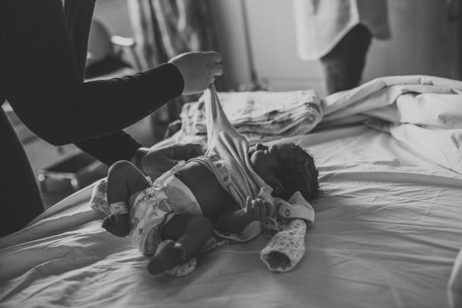 Newborn-and-Fresh-48-Photographer-Perth-SJOG-Mt-Lawley-35-of-51 black and white image of mother changing new baby with Perth Fresh 48 photographer at SJOG Mt Lawley