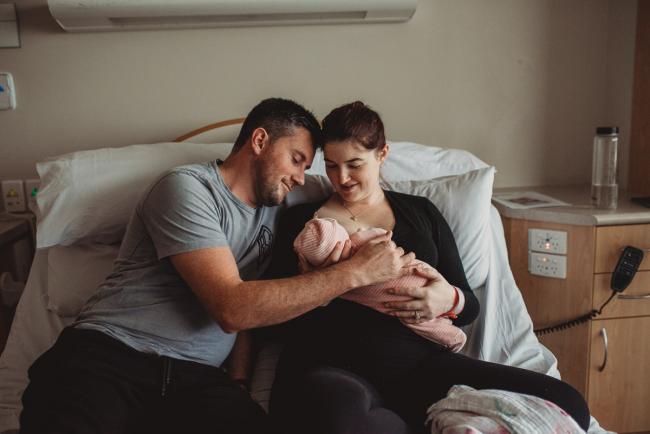 Mother and father holding their new baby with Perth Fresh 48 Photographer at SJOG Mt Lawley