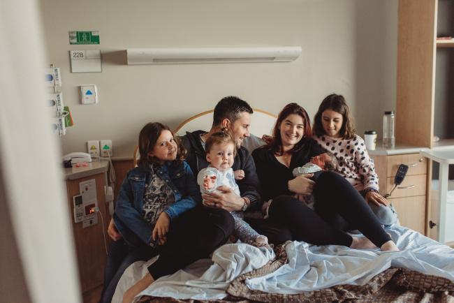 Newborn-and-Fresh-48-Photographer-Perth-SJOG-Mt-Lawley-6-of-51 Family of 5 sitting on hospital bed with Perth Fresh 48 photographer at SJOG Mt Lawley