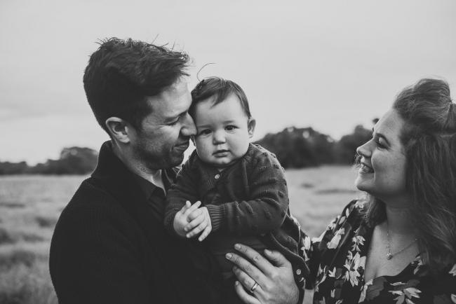 Black and white image of parents with daughter with Perth family photographer at Perry's Paddock