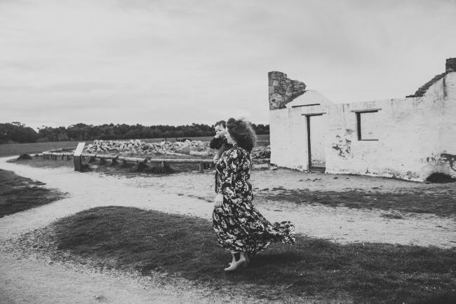 Black and white image of mother holding her daughter and spinning with Perth family photographer at Perry's Paddock
