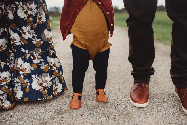Close up of little girl's feet next to her parents as they're walking with Perth family photographer at Perry's Paddock
