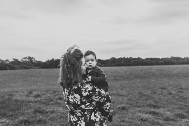 Black and white image of mother holding daughter with Perth family photographer at Perry's Paddock