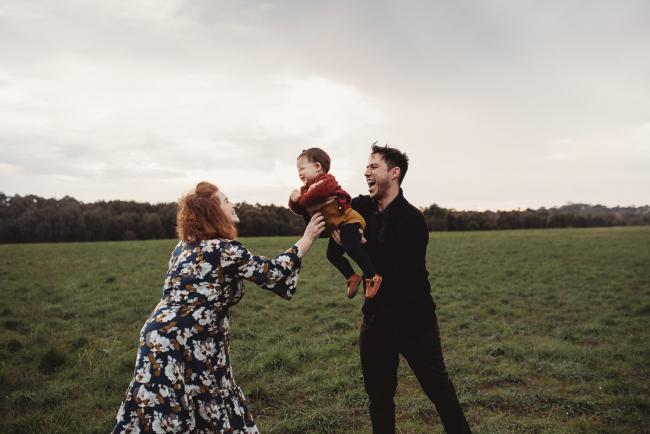 Father lifting daughter towards mother with Perth family photographer at Perry's Paddock