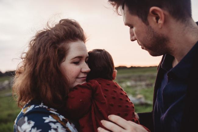 Daughter cuddling into mother with Perth family photographer at Perry's Paddock