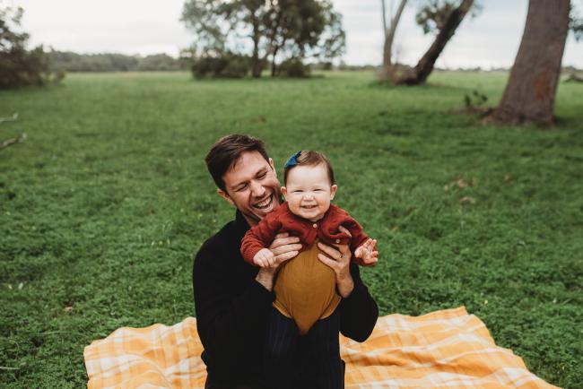 Father and daughter laughing with Perth family photographer at Perry's Paddock