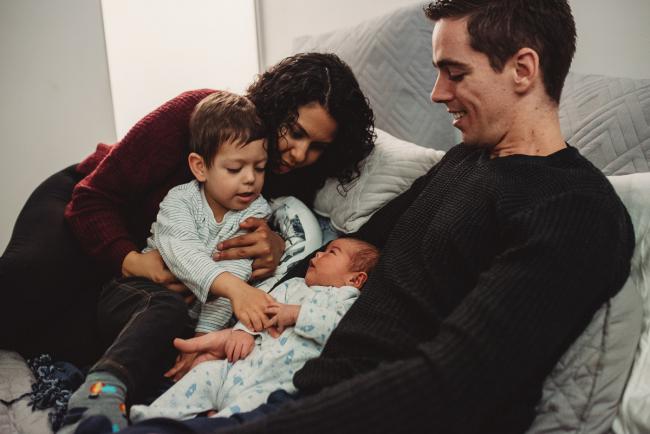 Family of four on the bed with Lifestyle Newborn Photographer Perth