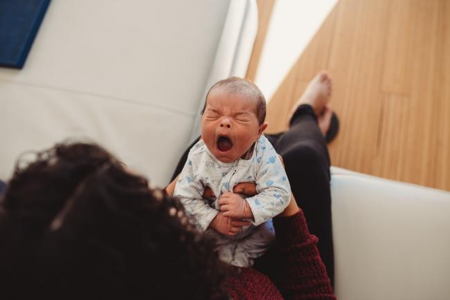 Baby yawning with lifestyle newborn photographer Perth