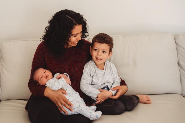 mother cuddling two sons with lifestyle newborn photographer Perth