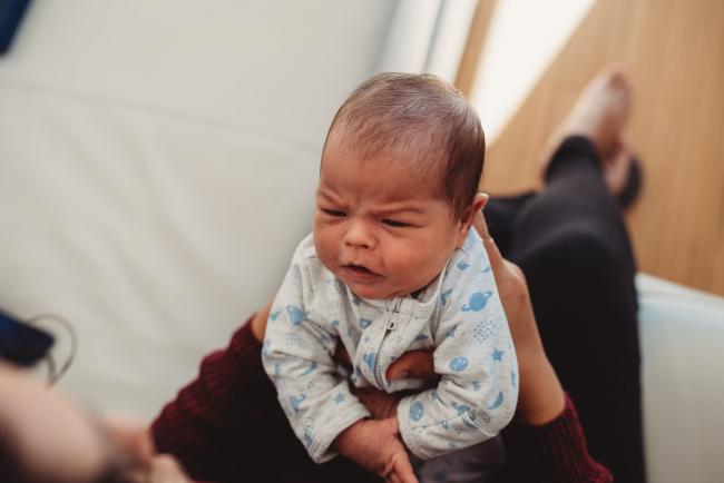 Baby frowning with lifestyle newborn photographer Perth