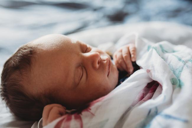 Perth-Newborn-Photographer-11-of-60 Side profile of new baby in floral wrap with Perth newborn lifestyle photographer