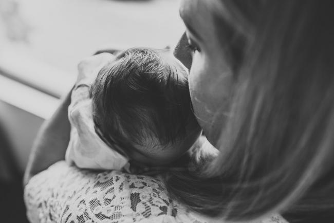 Perth-Newborn-Photographer-14-of-60 black and white image of mother kissing newborn head with Perth newborn lifestyle photographer