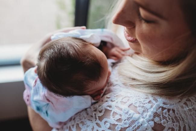 Perth-Newborn-Photographer-15-of-60 Mother looking down at newborn on her shoulder with Perth newborn lifestyle photographer