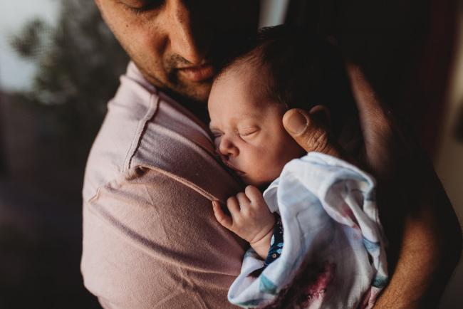 Perth-Newborn-Photographer-20-of-60 Father holding baby to chest with Perth newborn lifestyle photographer