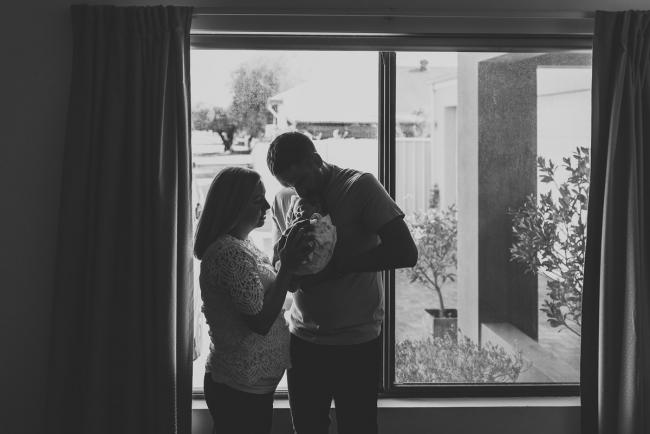 Perth-Newborn-Photographer-23-of-60 Black and white images of parents holding newborn in front of window with Perth newborn lifestyle photographer