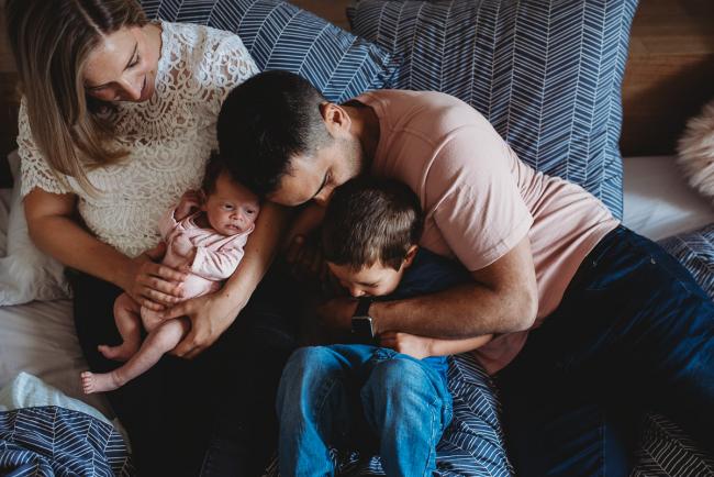 Perth-Newborn-Photographer-31-of-60 Mother holding newborn and dad wrapping arms around son's neck with Perth newborn lifestyle photographer