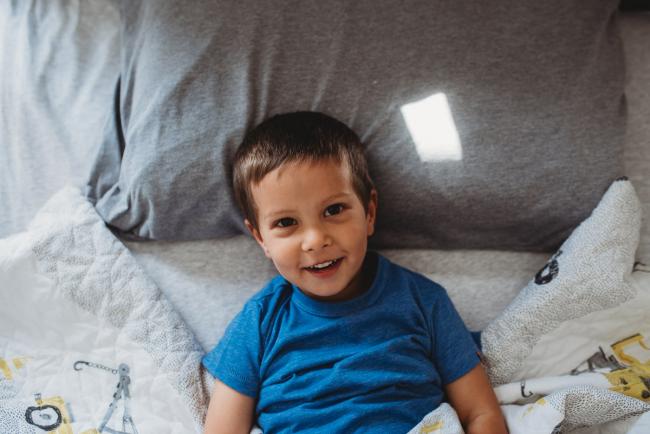 Perth-Newborn-Photographer-32-of-60 Little boy on bed with Perth lifestyle family photographer