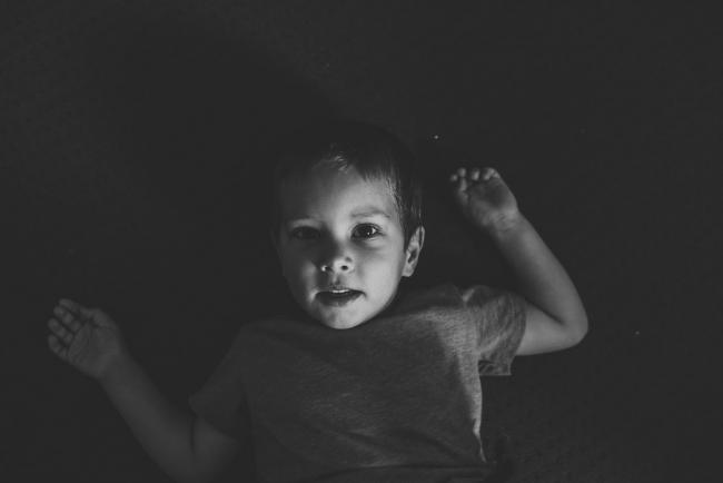 Perth-Newborn-Photographer-33-of-60 Black and white image of boy laying down with Perth lifestyle family photographer