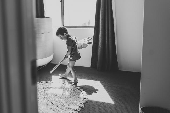 Perth-Newborn-Photographer-41-of-60 Black and white image of little boy playing in shadows with Perth lifestyle family photographer
