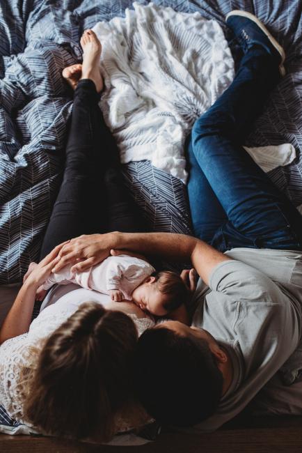 Perth-Newborn-Photographer-48-of-60 Top down image of mother breastfeeding with father next to them with Perth newborn lifestyle photographer