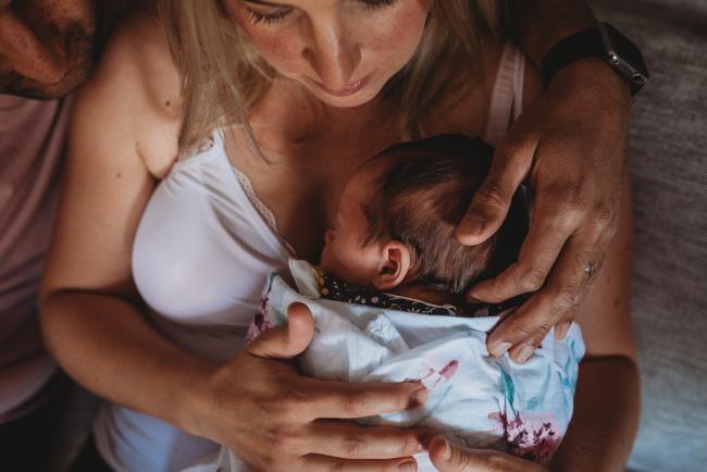 Perth-Newborn-Photographer-9-of-60 Baby on mother's chest with father touching her head with Perth newborn lifestyle photographer