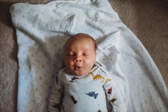 New baby on blanket with lifestyle newborn photographer Perth