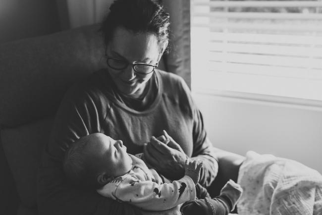 Black and white image of grandmother holding new baby with lifestyle newborn photographer Perth