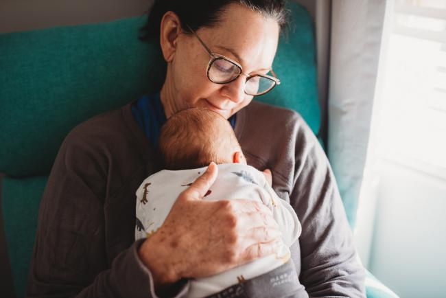 Grandmother holding new baby with lifestyle newborn photographer Perth