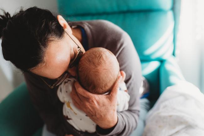 Grandmother kissing new baby with lifestyle newborn photographer Perth