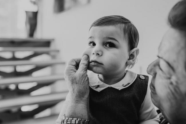 black and white image of little boy having his cheeks squeezed with Perth Events Photographer