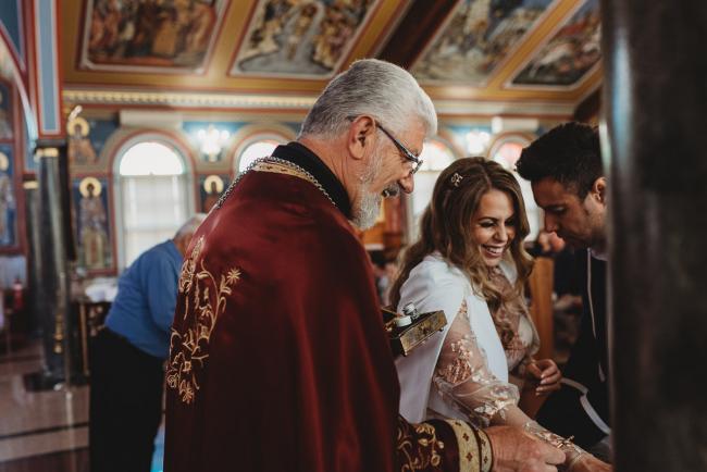 Priest and mother laughing during Christening at Macedonian Orthodox Church with Perth Events Photographer