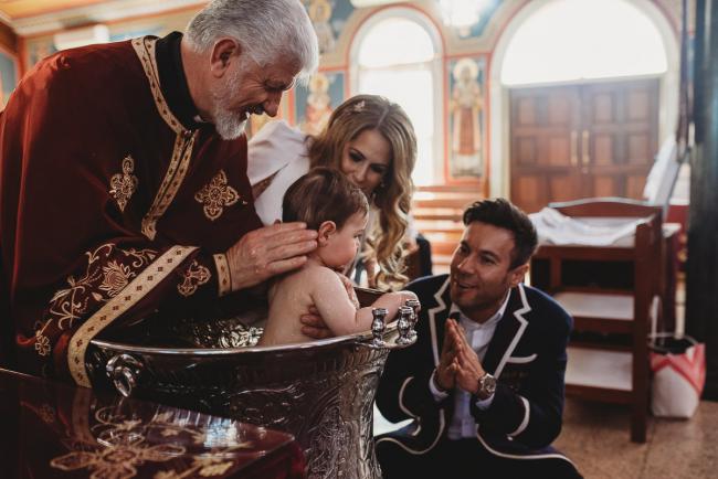 Little boy in water during christening at Macedonian Orthodox Church with Perth Events Photographer