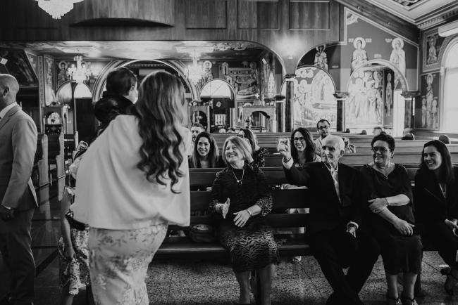 Black and white image of guests in pews during christening at Macedonian Orthodox Church with Perth Events Photographer