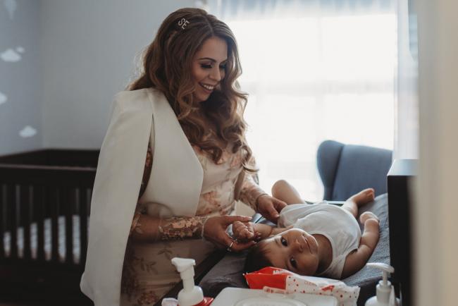 Mother changing her son with Perth Events Photographer