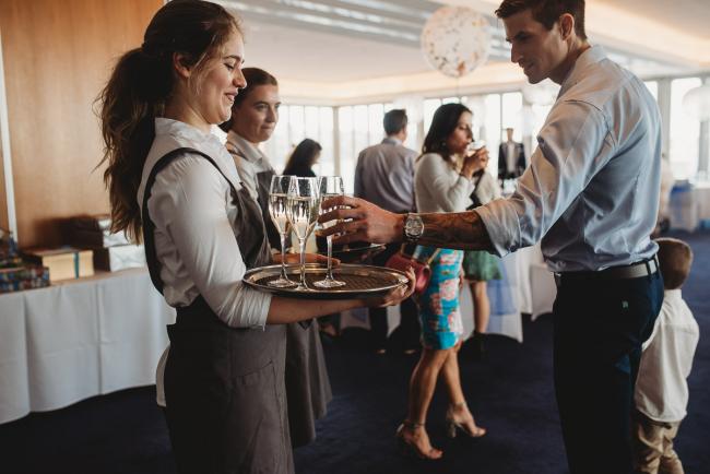 Waitress holding wine tray during first birthday party with Perth Events Photographer
