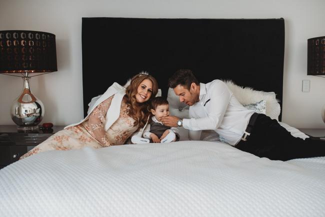 Parents on bed with little boy with Perth Events Photographer