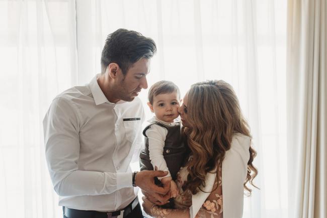 Parents holding son by window with Perth Events Photographer
