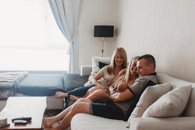 Lifestyle-Newborn-Photographer-Perth-11-of-69 Mother, father and grandmother sitting on couch with newborn baby with in-home lifestyle newborn photographer Perth