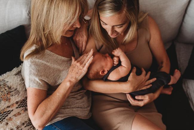 Lifestyle-Newborn-Photographer-Perth-14-of-69 Mother holding newborn baby on couch with grandmother cuddling into them with in-home lifestyle newborn photographer Perth