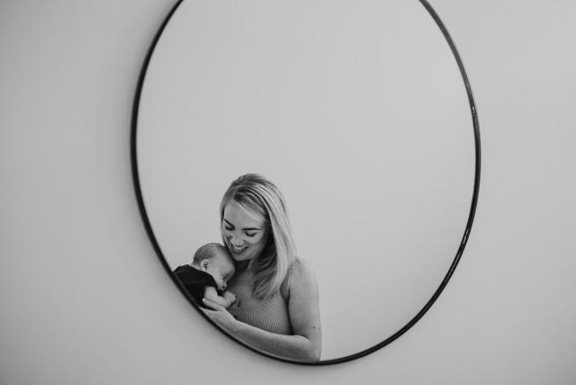 Lifestyle-Newborn-Photographer-Perth-2-of-69 black and white image of mother and newborn in front of mirror with in-home lifestyle newborn photographer Perth