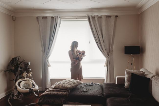 Lifestyle-Newborn-Photographer-Perth-22-of-69 Mother holding newborn baby in front of window with in-home lifestyle newborn photographer Perth