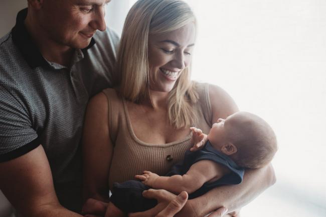 Lifestyle-Newborn-Photographer-Perth-27-of-69 Parents holding newborn baby by window with Perth newborn lifestyle photographer