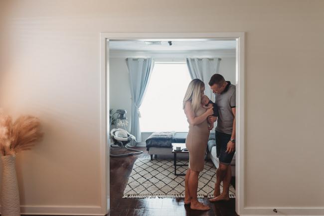 Lifestyle-Newborn-Photographer-Perth-3-of-69 Parents standing in door frame with newborn baby with in-home lifestyle newborn photographer Perth