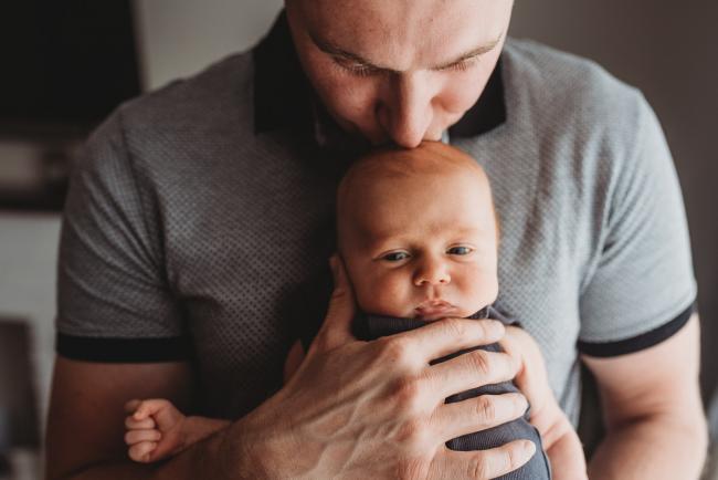 Lifestyle-Newborn-Photographer-Perth-32-of-69 Father kissing the head of newborn baby with in-home lifestyle newborn photographer Perth